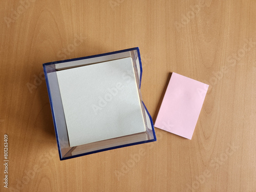 sticky notes and on wooden table background. Copy space for your text message or media and content. Top view image. empty notes.