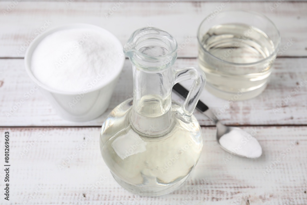 Vinegar and baking soda on white wooden table Vinegar and baking soda on white wooden table