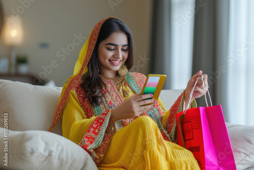 young woman seating at home and using smartphone