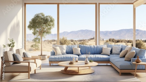 Blue sofa in a modern living room with large windows and a beautiful view of the mountains © duyina1990