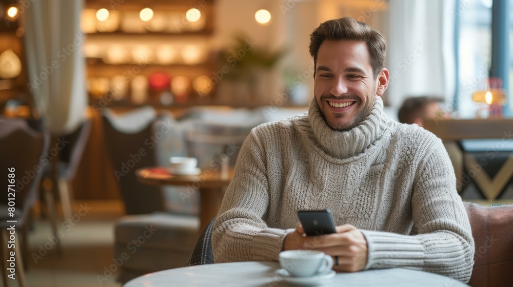 Man in turtleneck sweater using smartphone in cafe Man in turtleneck sweater using smartphone in cafe