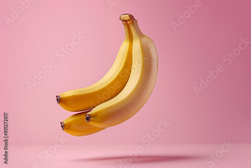 Levitating banana on pink background