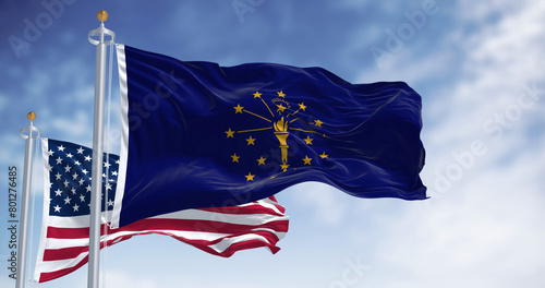 Indiana state flag waving with the national flag of the US on a clear day