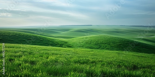 Green rolling hills under blue sky with clouds