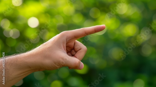 person pointing at something in front of them with a blurred background