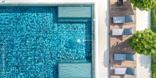 Blue mosaic tiles swimming pool with sun loungers