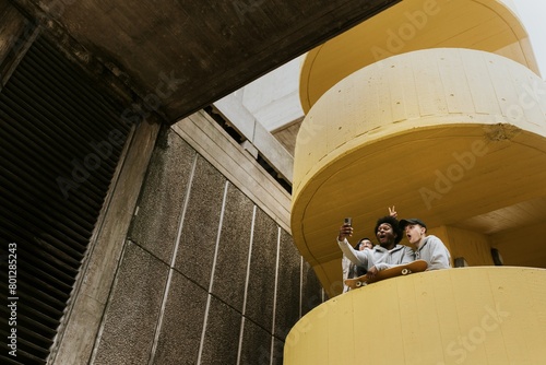 Diverse skaters taking selfie at yellow stairs
