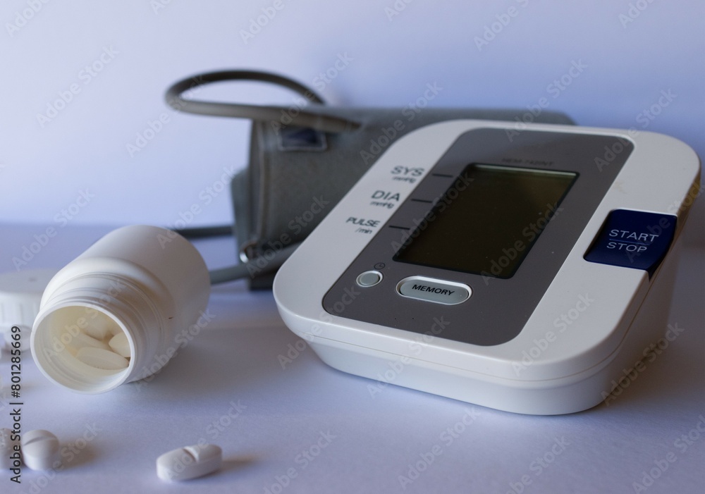 Blood pressure measuring equipment together with a container of medicine and pills. Health care concept Blood pressure measuring equipment together with a container of medicine and pills. Health care concept