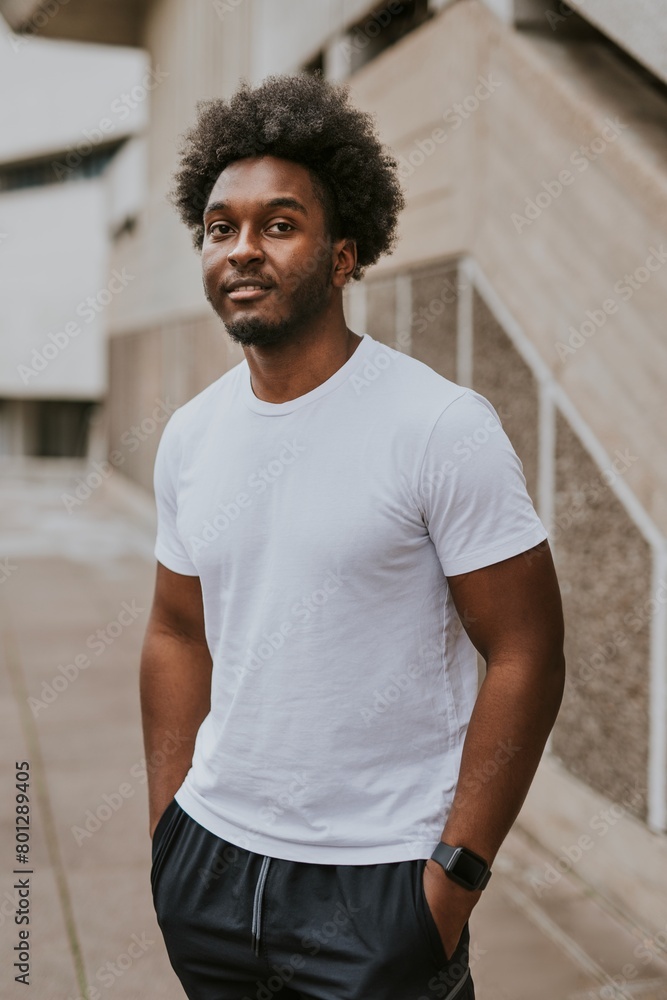 Cool man in plain whit tee, standing by stairs Cool man in plain whit tee, standing by stairs