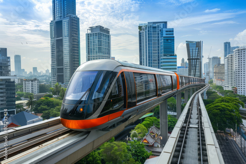 Modern train rushes along overpass with high rise buildings in background. Futuristic public transport.