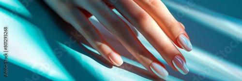 Woman hand with nude shades nail polish on her fingernails photo