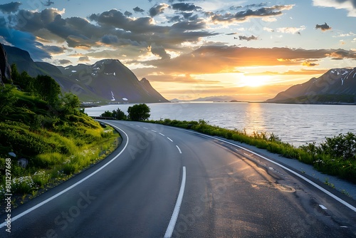 A coastal road in Norway, with the sea on one side and cliffs to another, bathed by the golden sunset light photo