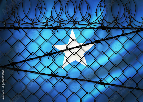 Somalia flag behind barbed wire fence