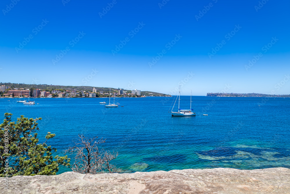 Ocean Bay with Boats in front of Suburb of Sydney seen from Manly, Sydney, Australia.