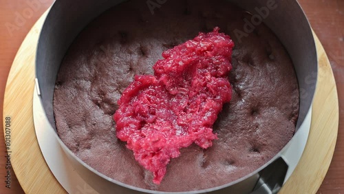 Cherry pie. Process. The confectioner lays out cherry puree for making a cake