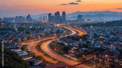 A photo of a city with a lot of lights and a highway running through it. © charunwit
