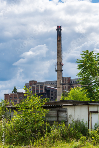 An old building and chimney at a coal mine in Gliwice, Poland. They make an oddly satisfying mix of colours along with the nature below and sky above.