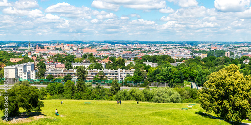 View of Kraków, Poland, seen from Krakus Mound. On a warm summer day like this, the blue sky and light clouds above adds to the beauty of the scenery.
