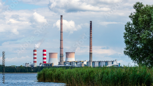 Rybnik power station at Lake Rybnickie (Poland). White smoke comes up a chimney close to the characteristic red and white checkered cooling towers.