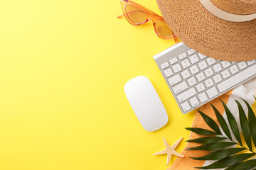 Stylish remote work concept with keyboard setup and summer holiday accessories, on a bright yellow backdrop, crafted to appeal to digital nomads and remote workers looking for a creative workspace