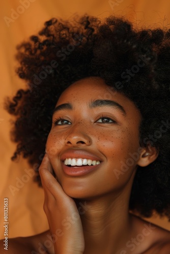 Black woman pondering in studio on orange background about cosmetics and wellbeing. Health, skin, and care with a model female posing for antiaging product © LukaszDesign