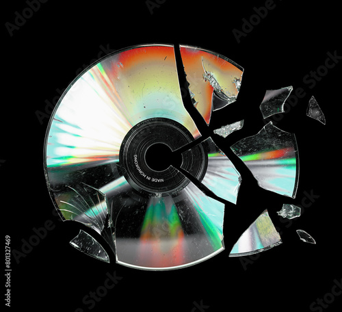 Shattered cd isolated on black background © Anjar G