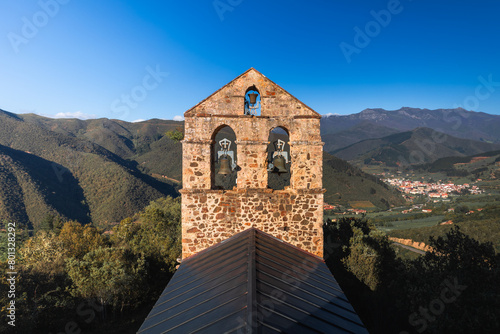 Panoramic view of north spanish landscape. Monastery in foreground and small village in background. photo