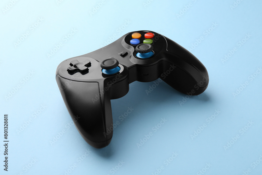 Wireless game controller on light blue background Wireless game controller on light blue background