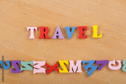 TRAVEL word on wooden background composed from colorful abc alphabet block wooden letters, copy space for ad text. Learning english concept. photo