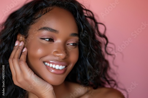 A happy black woman with afro hair and conditioner on pink studio background. Afro model, haircare, scalp cream, skin relaxer, and beauty upkeep