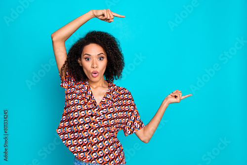 Photo of charming impressed lady wear print shirt showing fingers empty space isolated blue color background