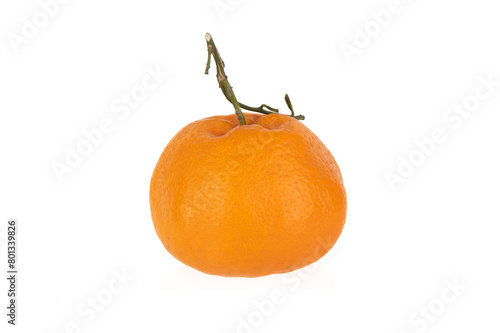 Ripe unpeeled tangerine with a sprig on a white background. © svdolgov