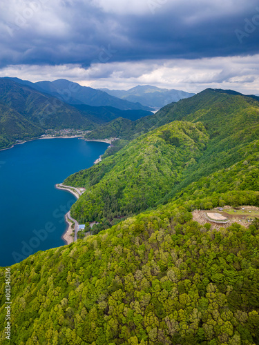 Aerial view of lush green forest surrounding a volcanic lake (Lake Saiko, Yamanashi, Japan) © whitcomberd