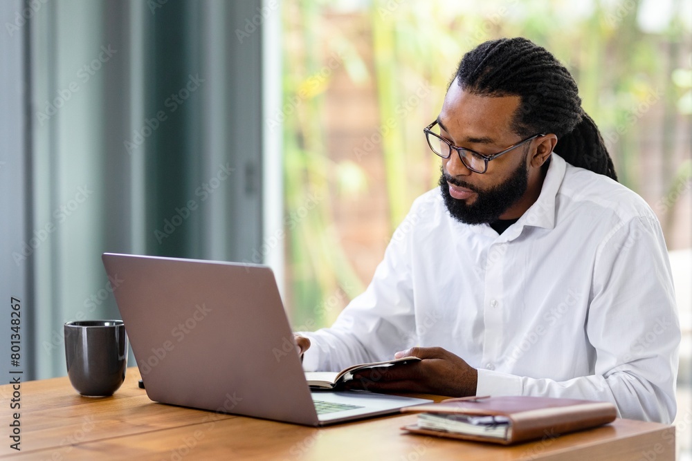 Cool businessman working from home on laptop Cool businessman working from home on laptop