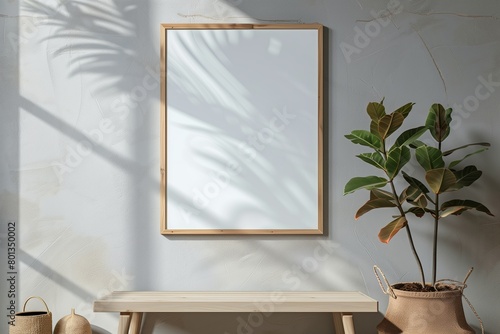 Mockup of a blank framed painting placed on a light colored wall next to flowers. Empty space