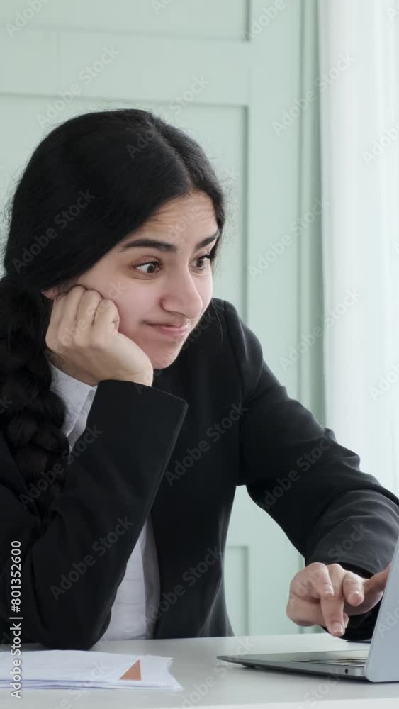 Furious Indian woman working in the office with laptop. Concept of a distress, failure, trouble in the office work. Vertical video. Furious Indian woman working in the office with laptop. Concept of a distress, failure, trouble in the office work. Vertical video.