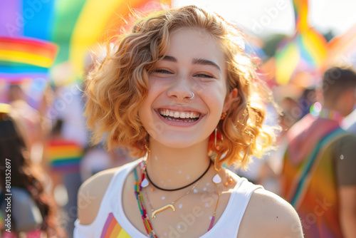 photo gainst a backdrop of celebration, a young happy transgender person smiles brightly for the camera during a Gay Pride event, embodying the spirit of love and acceptance. Pride photo