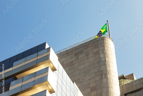 Prédio com sacada e bandeira do brasil no topo.  photo