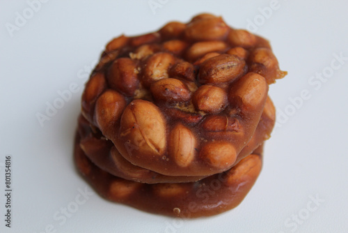 Gula kacang, or Ampyang, is a traditional snack from Indonesia, made from roasted peanuts and brown sugar. Isolated on white background