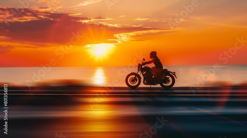 A man riding a motorcycle down a beach at sunset. © JK_kyoto