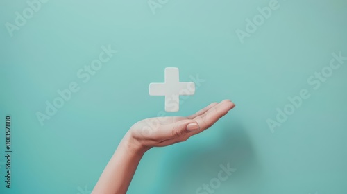 A hand holding a plus sign.