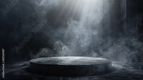 A spotlight shines down on a dark, concrete stage surrounded by smoke. photo