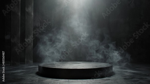 A spotlight shines down on a dark, concrete stage surrounded by smoke. photo