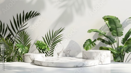 White marble podiums with tropical leaves on the white background. photo
