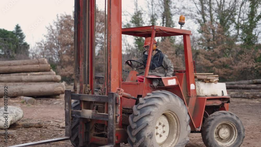 An operator moving a tractor lift An operator moving a tractor lift