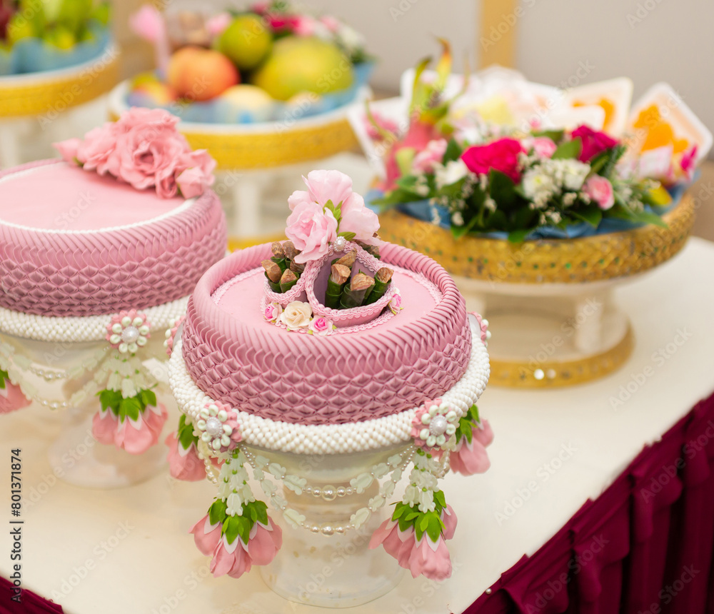 A pink tray with areca nuts and betel leaves is reserved for copying space.