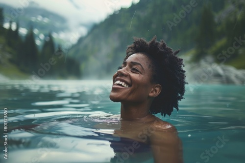 African American woman laughing joyously while enjoying a cold water therapy session in a natural mountain lake, , moody lighting