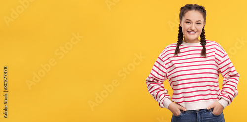 Smiling woman with braces on orange background. Banner design with space for text