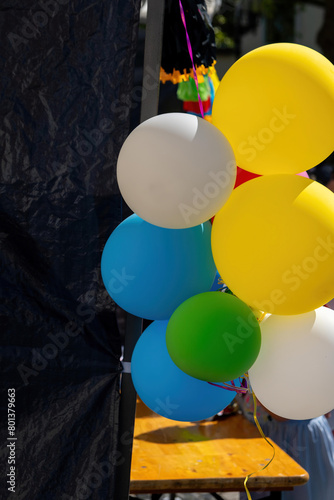 colorful balloons in front of a shop window in the city © funkenzauber