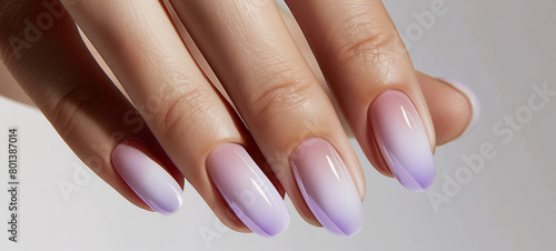 Effortlessly chic  this minimalist manicure showcases a subtle gradient of soft lavender transitioning seamlessly to pale lilac